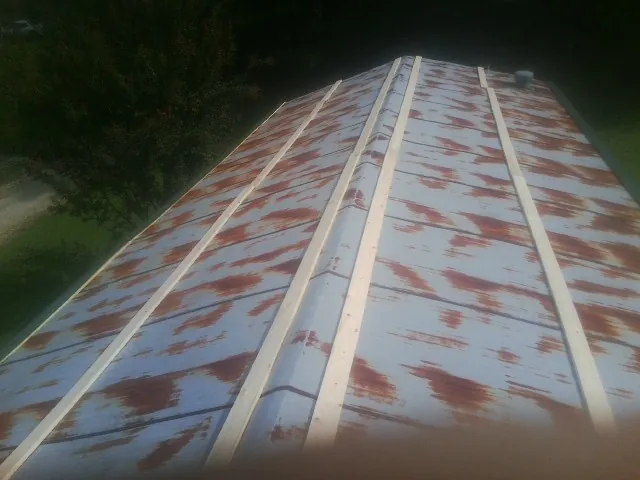 Rusted metal roof panels with new wood purlins before replacement — Storm Damage Roof Repair in Fort Loudon by Roofing Brothers