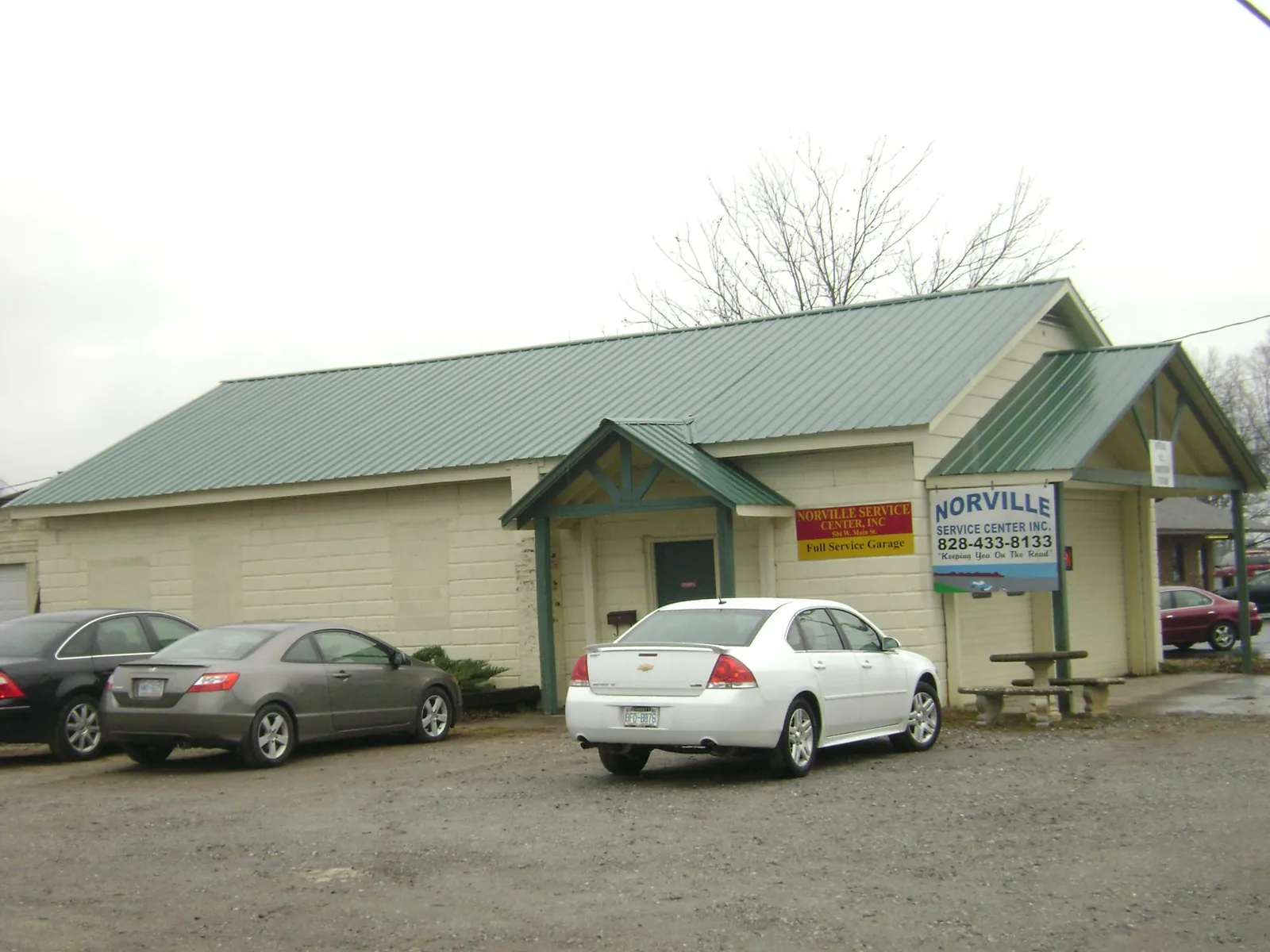 Green metal roof on a service garage with a covered entry in Fort Loudon